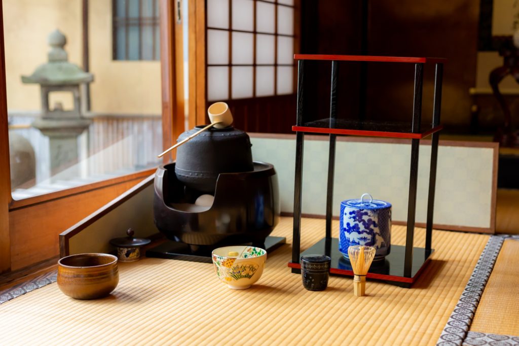 Iron kettle on the sunken hearth with matcha bowl and chashaku