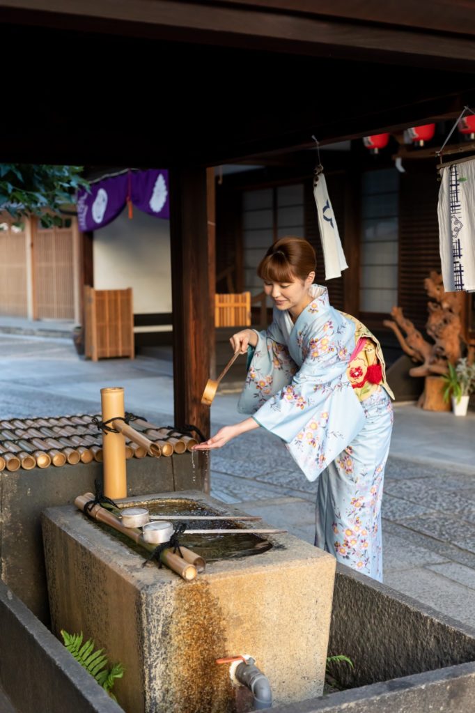 A guest at the temple's purification water basin